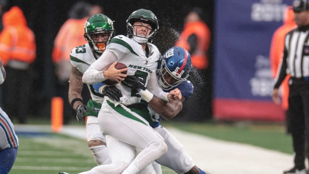 Jets' QB Zach Wilson gets hits by a Giants' defender